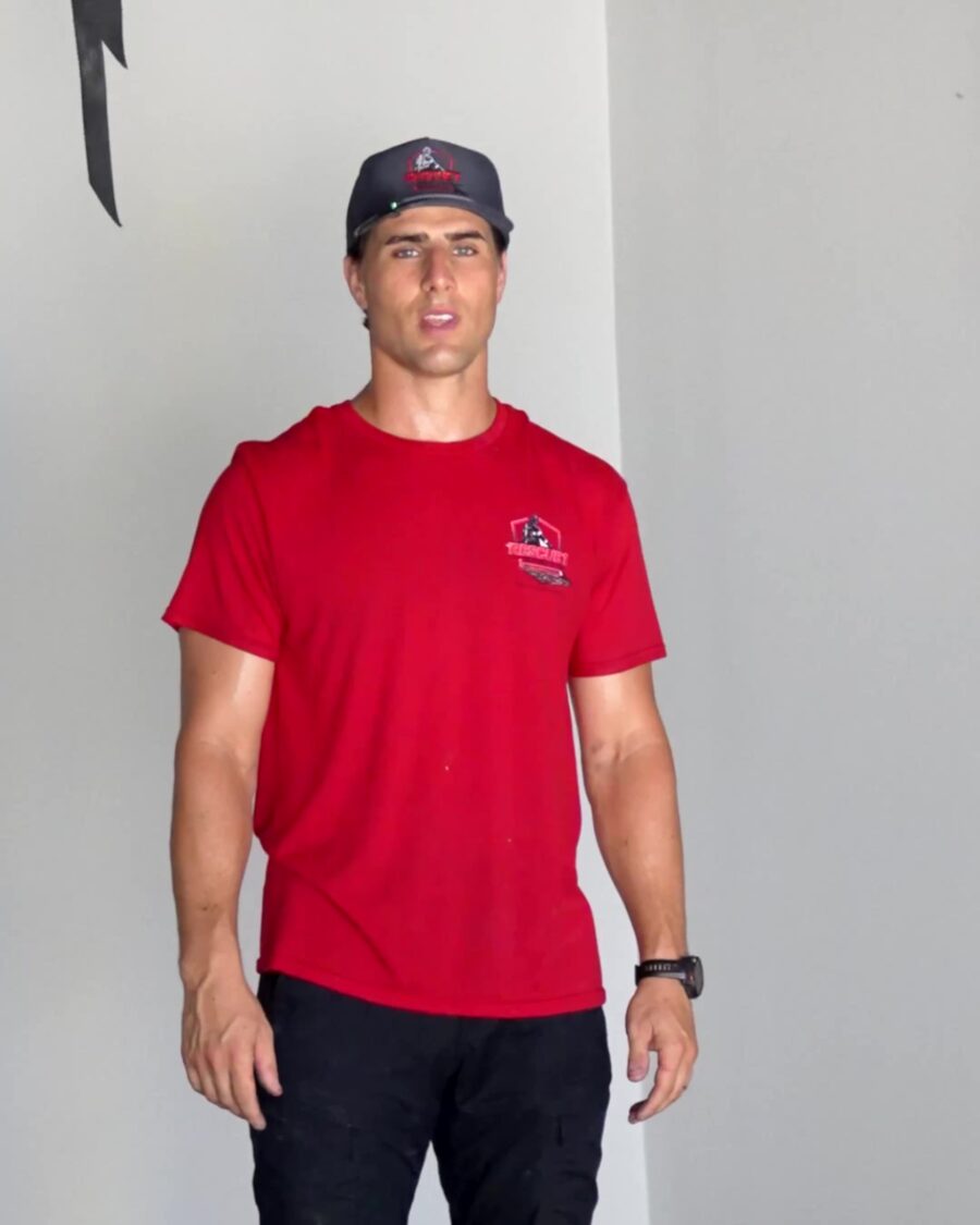 Drew Becker, owner of Rescue 1 Epoxy, standing on a freshly coated grey floor