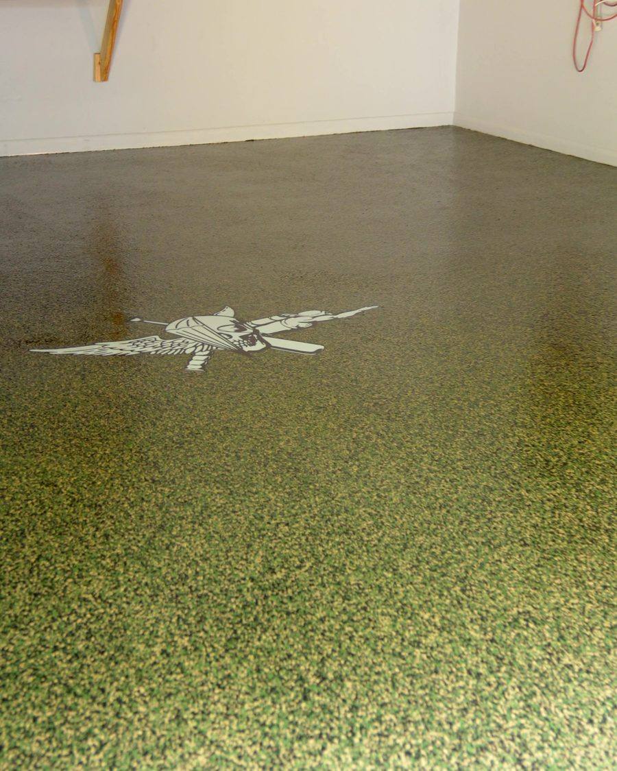 Finished chip flake floor with a custom firefighter stencil inlay