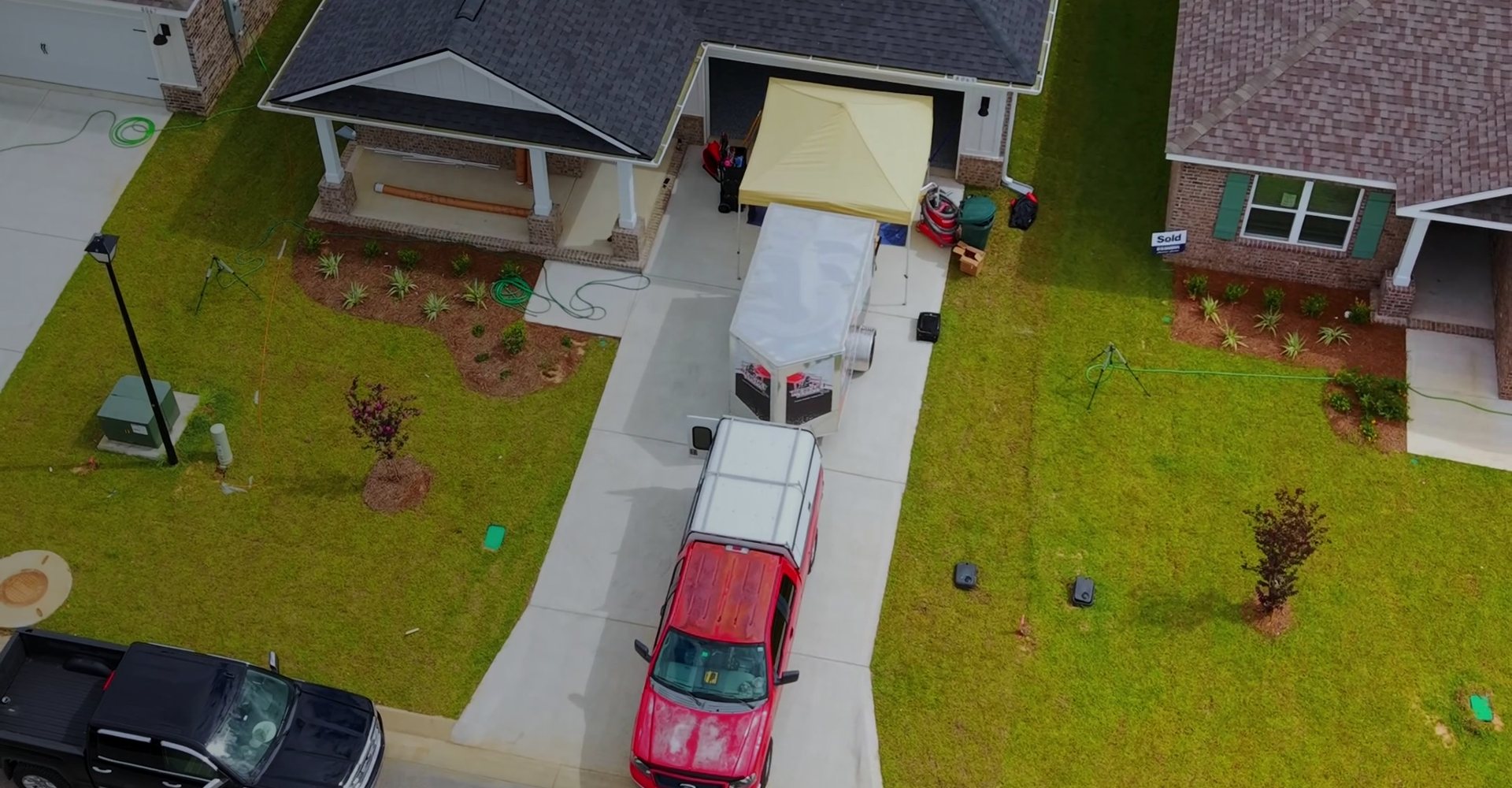 Aerial view of a Rescue 1 Epoxy job site with the work trailer in the driveway
